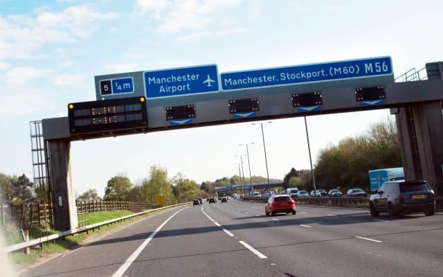 road with signs to manchester